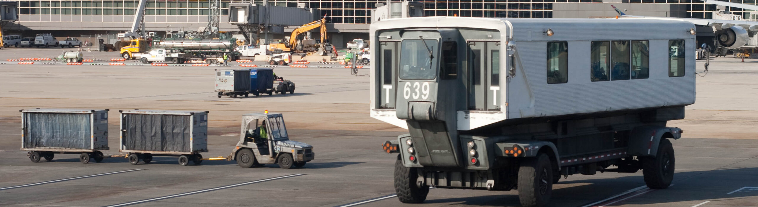 A busy airport terminal with travelers lining up at security checkpoints