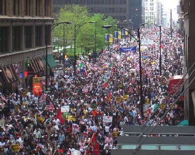 Protesters holding signs advocating for police and immigration accountability in the U.S.