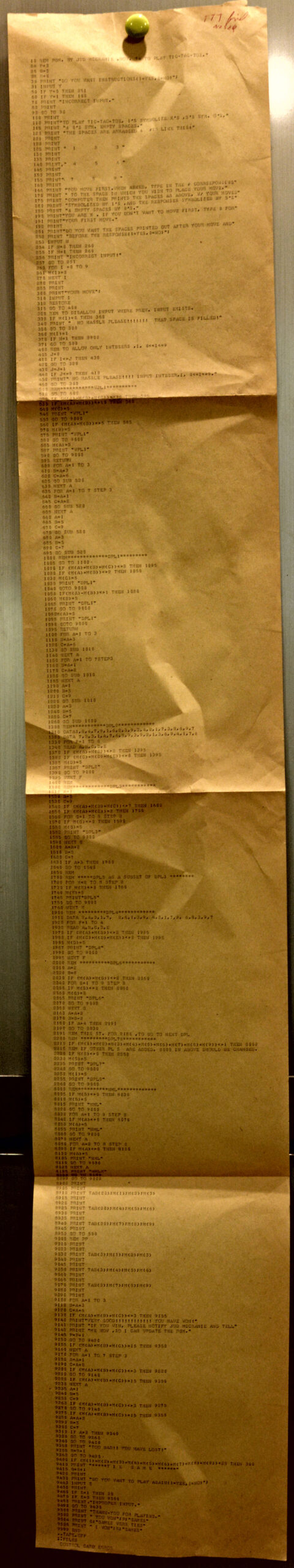 A team of game developers at work in a high-tech office, reviewing code on screens