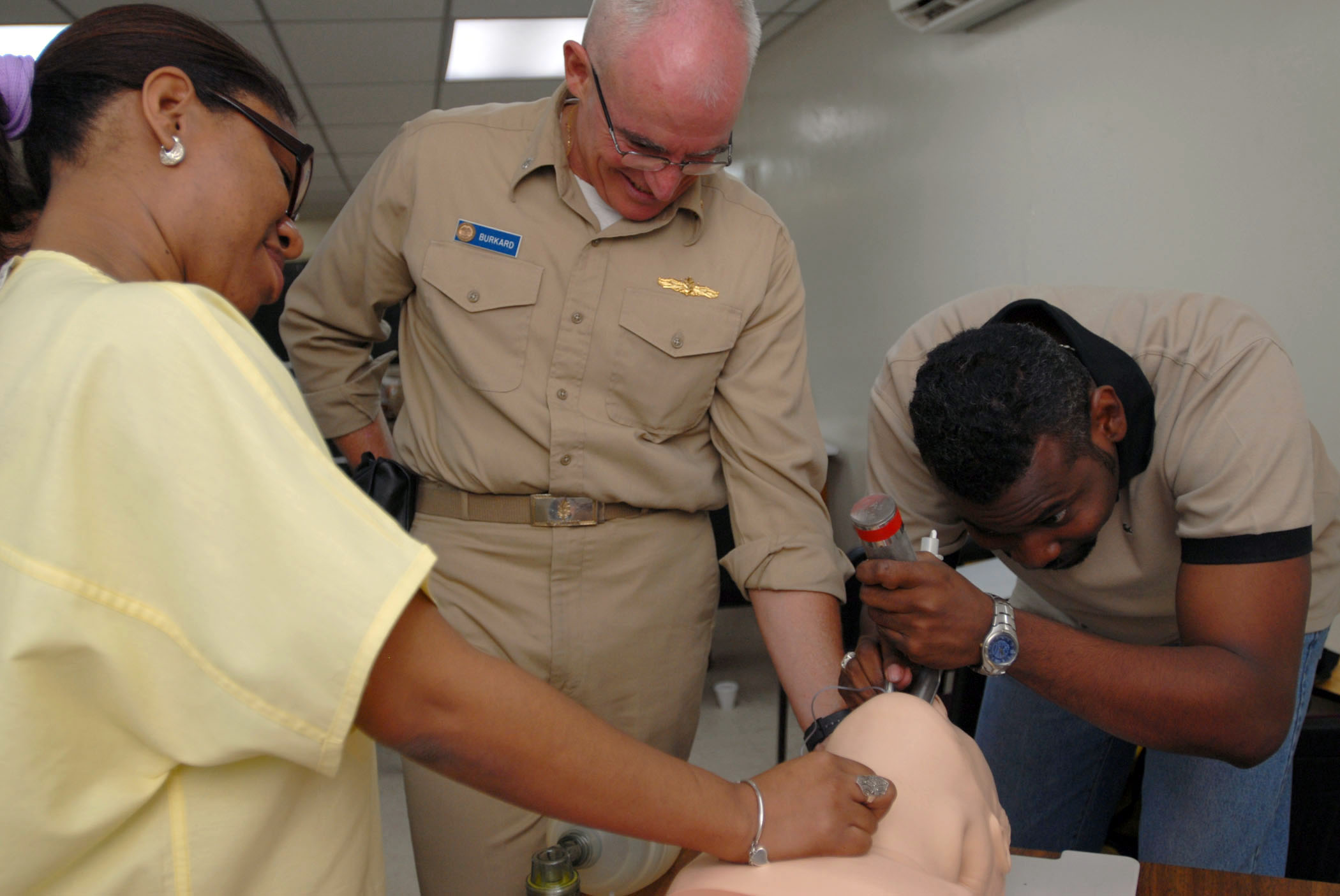 Emergency room staff treating a patient on a stretcher in a hospital setting