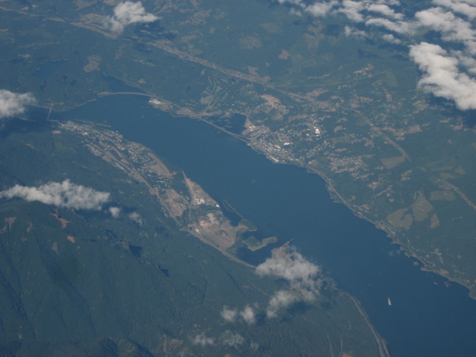 An aerial shot of the U.S.-Canada border with trade trucks lined up for inspection