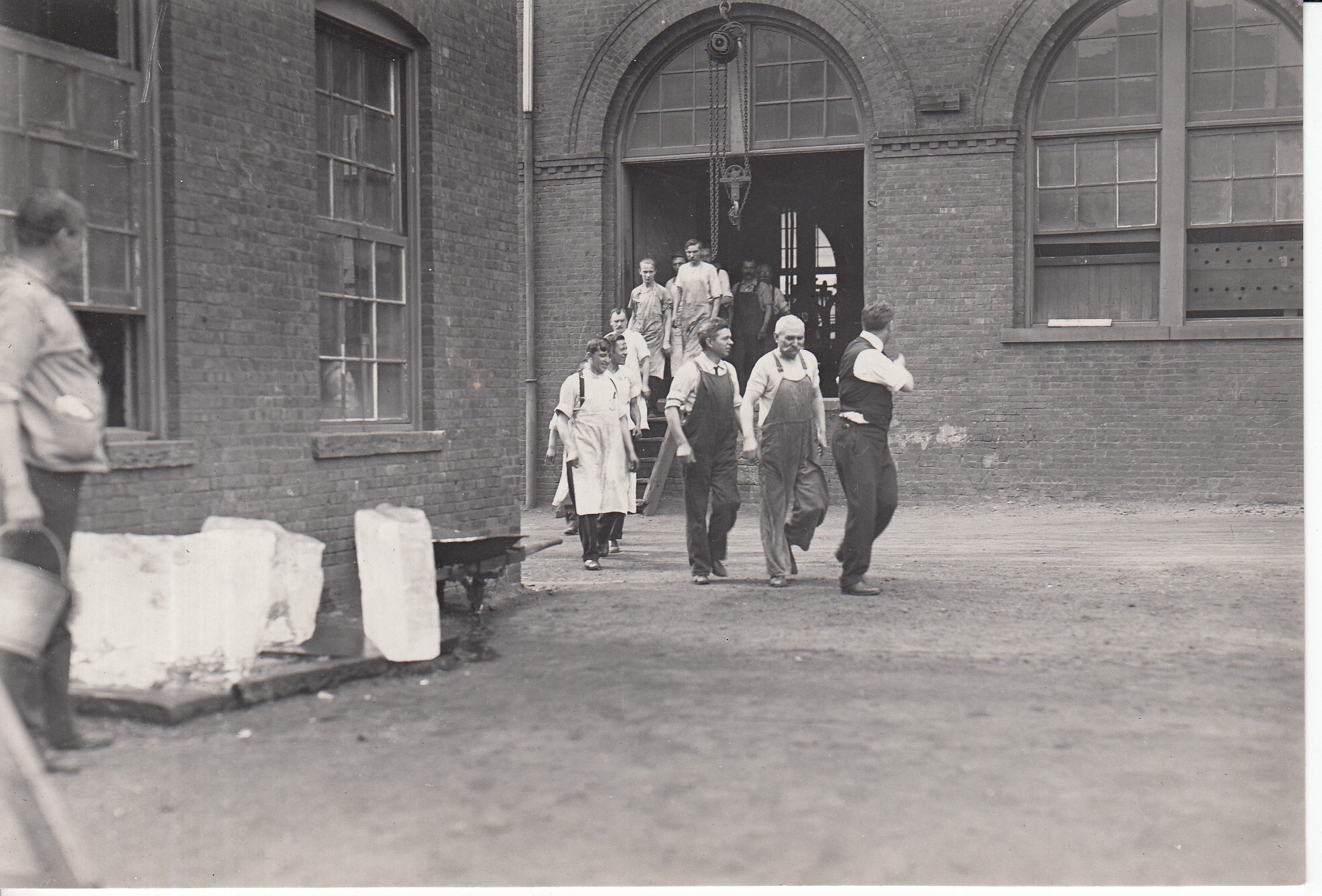 A silhouette of office workers leaving a corporate building at dusk