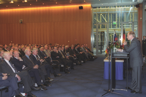 A pensive Vladimir Putin at a policy meeting, flanked by government officials