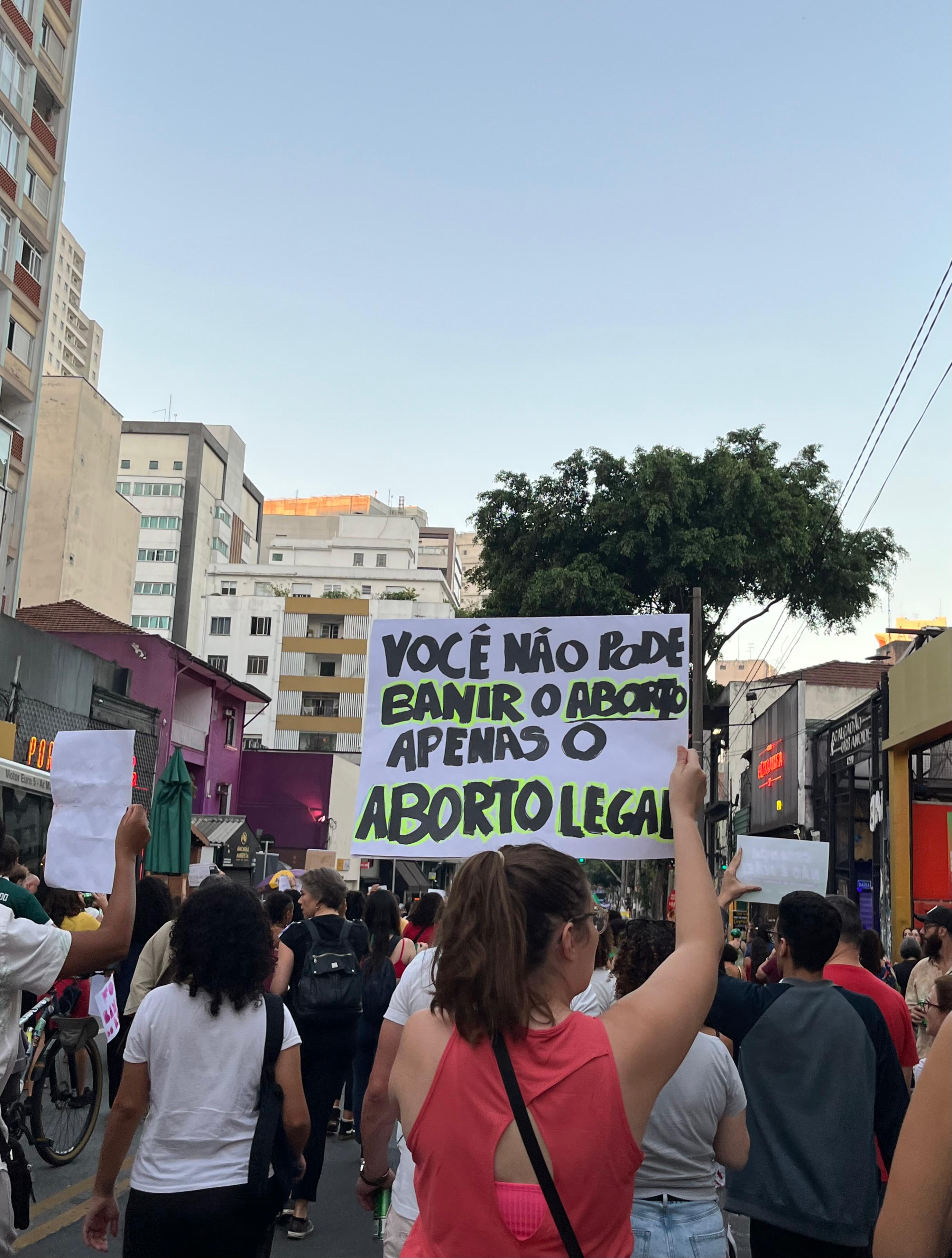 Women marching in a protest with signs about reproductive rights