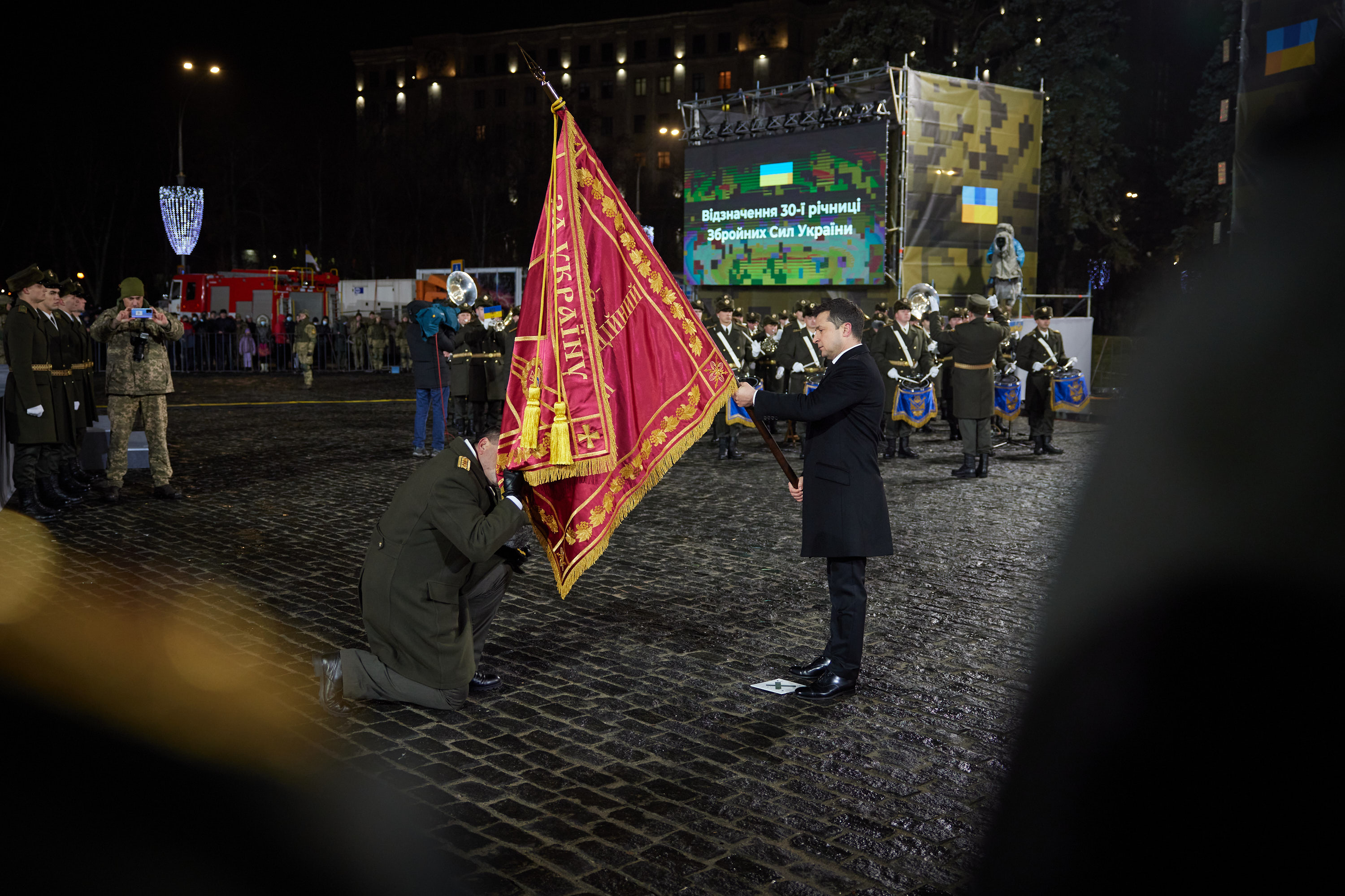 Ukrainian soldiers waving the national flag atop a reclaimed position